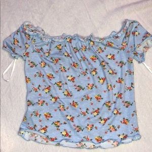 A light blue with flowers off the shoulder shirt